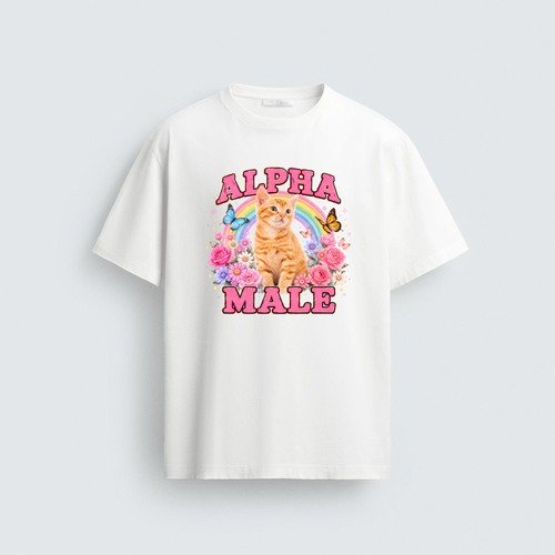 A white unisex regular fit t-shirt featuring a colorful graphic of an orange kitten, a rainbow, butterflies, and pink flowers with the ironic text Alpha Male in bold pink letters.