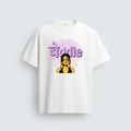 A white t-shirt featuring a graphic illustration of a skeptical South Asian woman with a bindi and hoops under the fusion text "बेddie" in purple color 