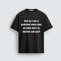 A flat lay mockup of a black unisex t-shirt featuring the white text "how do I get a girlfriend when they all think that I'm autistic and gay?" printed across the chest.