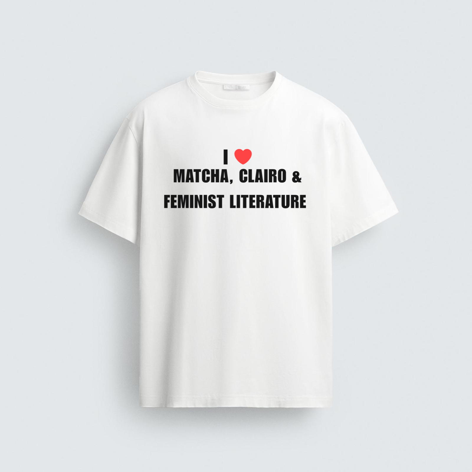 A white unisex t-shirt featuring the ironic text 'I [red heart] MATCHA, CLAIRO & FEMINIST LITERATURE' in bold black block letters across the front.