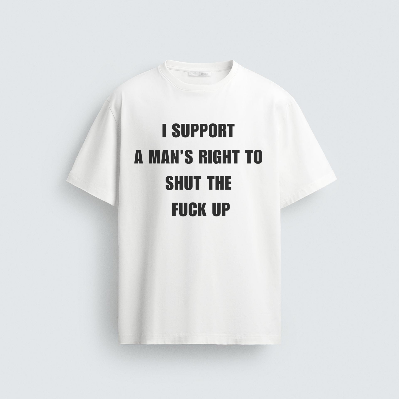 A white unisex regular fit graphic t-shirt with bold black text that reads "I Support A Man's Right To Shut The Fuck Up," laid flat on a light grey background.
