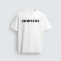 A minimalist white unisex t-shirt displayed flat against a grey background, featuring the word UNEMPLOYED printed across the chest in bold, black capital letters