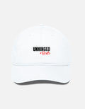 A minimalist white baseball cap featuring the bold "UNHINGED Brats" logo in black and red text, designed with a modern, adjustable fit.