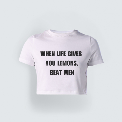 White cropped baby tee with bold black text reading "When Life Gives You Lemons, Beat Men," styled in a Gen-Z streetwear aesthetic.