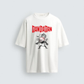 A photograph of a plain white oversized cotton tee from image_0.png. In the center, a graphic shows the jagged red text "DANDADAN" above a punk-style black and white illustration of two aggressive characters with spiky hair, dynamic and shouting.